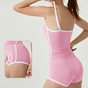 Slim fit pink yoga camisole and shorts set featuring white contrast trim for fitness
