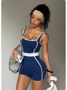 Detailed view of a navy blue and white contrast seamless yoga jumpsuit worn by a model