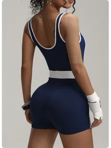 Navy blue seamless athletic romper with white contrast piping shown from the back
