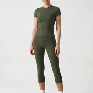 Two-piece olive green women's workout set with short sleeve top and capri leggings