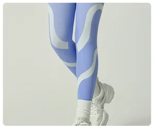 Detail of blue and white wavy pattern ski thermal leggings with ribbed texture.