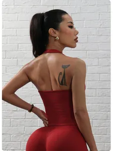 Back view of a vibrant red seamless halter sports top highlighting the stylish open back design