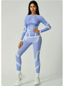 Full body view of a women's blue quick-dry thermal ski base layer set on model in studio