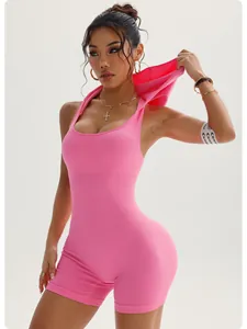 Detail shot of the pink ribbed sleeveless hooded yoga romper with premium textured fabric