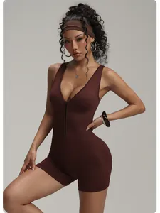 Close-up view of a brown ribbed yoga romper featuring a front zipper detail on model