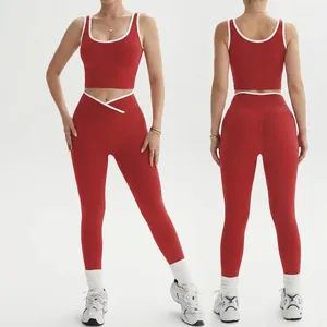 Women's red seamless yoga set featuring contrast trim tank top and peach lift leggings
