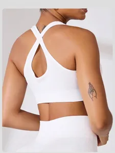 Detailed macro view of white ribbed high-impact sports bra with cross back design