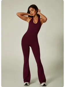 Full body view of a burgundy halter neck seamless yoga jumpsuit with flared legs