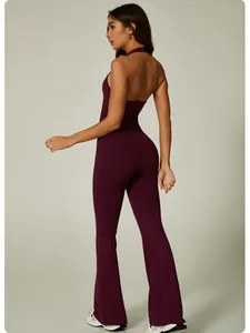 Back view of seamless wine red halter yoga jumpsuit featuring sexy backless design and flares