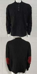 Detail view of men's black cable knit sweater with buttons and red elbow patches