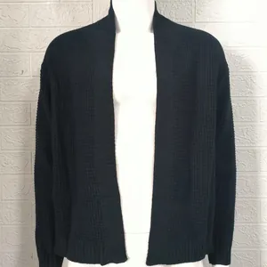 Close-up detail of black men's knit cardigan showing waffle texture and ribbed sleeve cuffs.