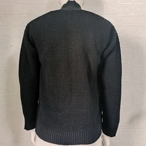 Detailed back view of a black waffle knit cardigan sweater showing premium texture.