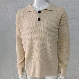 Close-up detail of a beige men's waffle knit sweater with lapel collar and buttons