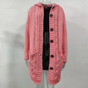 Detailed view of pink long-line cable knit cardigan with large black buttons.