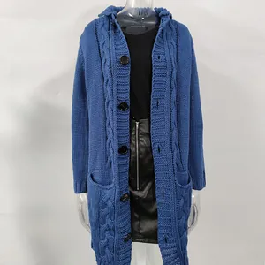Detail view of a long blue cable-knit cardigan with black buttons on a mannequin