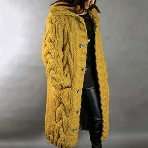 A detailed view showing the chunky cable knit texture of this long yellow cardigan