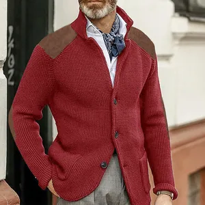 Detail of men's red knit cardigan with brown suede shoulder patches and textured finish