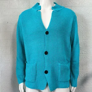 Detailed view of a bright blue waffle-knit men's cardigan featuring three black buttons and pockets