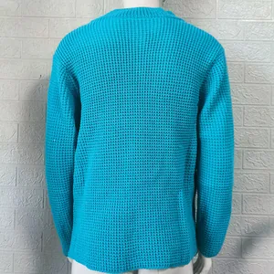 Detailed back view of a men's bright cyan waffle knit sweater with textured stitch patterns.
