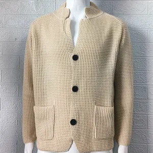 Front detail of men's beige waffle knit cardigan with stand collar and buttons