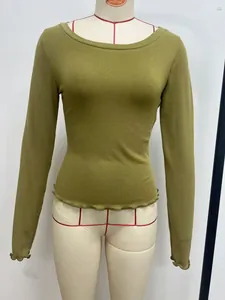 Close-up of moss green long sleeve top with lettuce edge hem on mannequin
