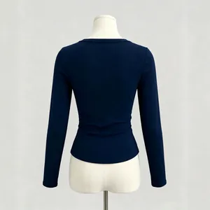 Back view of a navy blue slim fit ribbed long sleeve t-shirt for women on a mannequin