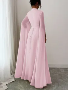 Back view of pink party gown showing elegant lace-up waist and flowing split cape sleeves
