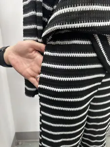 Close-up of pocket detail on black and white striped casual textured lounge set