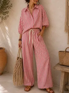 Full view of red and white striped vacation outfit set styled with a rustic boho background