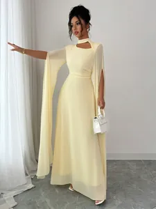Elegant pale yellow slim-fit evening gown featuring dramatic cape-style sleeves for party