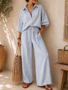 Detailed shot of a woman in a blue striped two-piece set with wide-leg beach pants