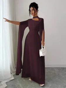 Elegant deep purple maxi dress with dramatic cape sleeves and chic cutout neckline.