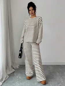 Elegant women's striped knit lounge set featuring a long sleeve top and wide-leg pants