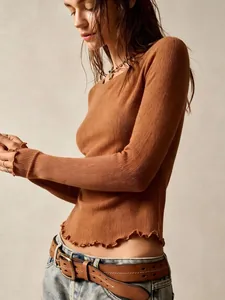 Detailed view of brown retro slim fit top with lettuce edge hem and ribbed texture