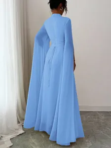 Detailed back view of a light blue maxi dress featuring cape sleeves and lace-up ties.