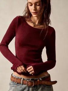 Detail view of burgundy slim-fit long sleeve top with lettuce edge hem texture