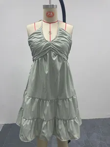 Detailed view of a sage green halter tiered ruffle dress shown on a mannequin