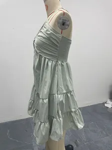 Detailed side view of a sage green tiered ruffled halter dress displayed on a mannequin