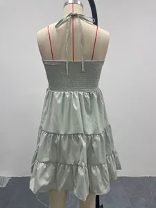 Detailed back view of a sage green halter tiered ruffle dress displayed on a mannequin