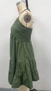 Detail of olive green halter v-neck tiered mini dress with smocked back for vacation.