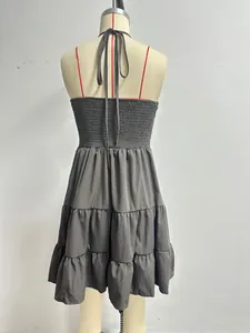 Detailed back view of a dark grey tiered ruffle halter neck sundress for vacation