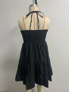 Back view of a black halter neck tiered ruffle dress with a smocked back detail.
