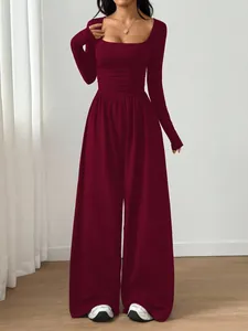 Detail of long-sleeve square-neck wide-leg burgundy jumpsuit in slim fit style