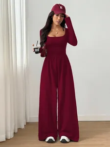 Burgundy long-sleeved square-neck jumpsuit with wide-leg design styled on a model