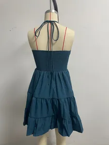 Detail of back shirring and halter tie on teal tiered ruffle vacation dress.