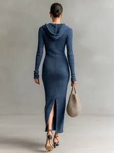 Back view of a slim fit hooded knit maxi dress in slate blue with a back slit detail