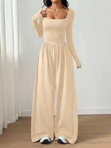 Elegant beige long-sleeved square-neck wide-leg jumpsuit with slim fit waist detail