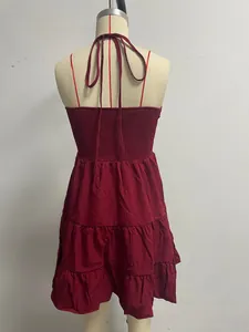 Red tiered halter vacation dress featuring a smocked back design on a mannequin