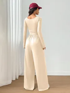 Back view of a chic cream long-sleeve wide-leg jumpsuit with a flattering slim fit