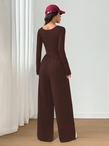 Back view of a chic long-sleeve wide-leg jumpsuit in dark brown, slim fit design